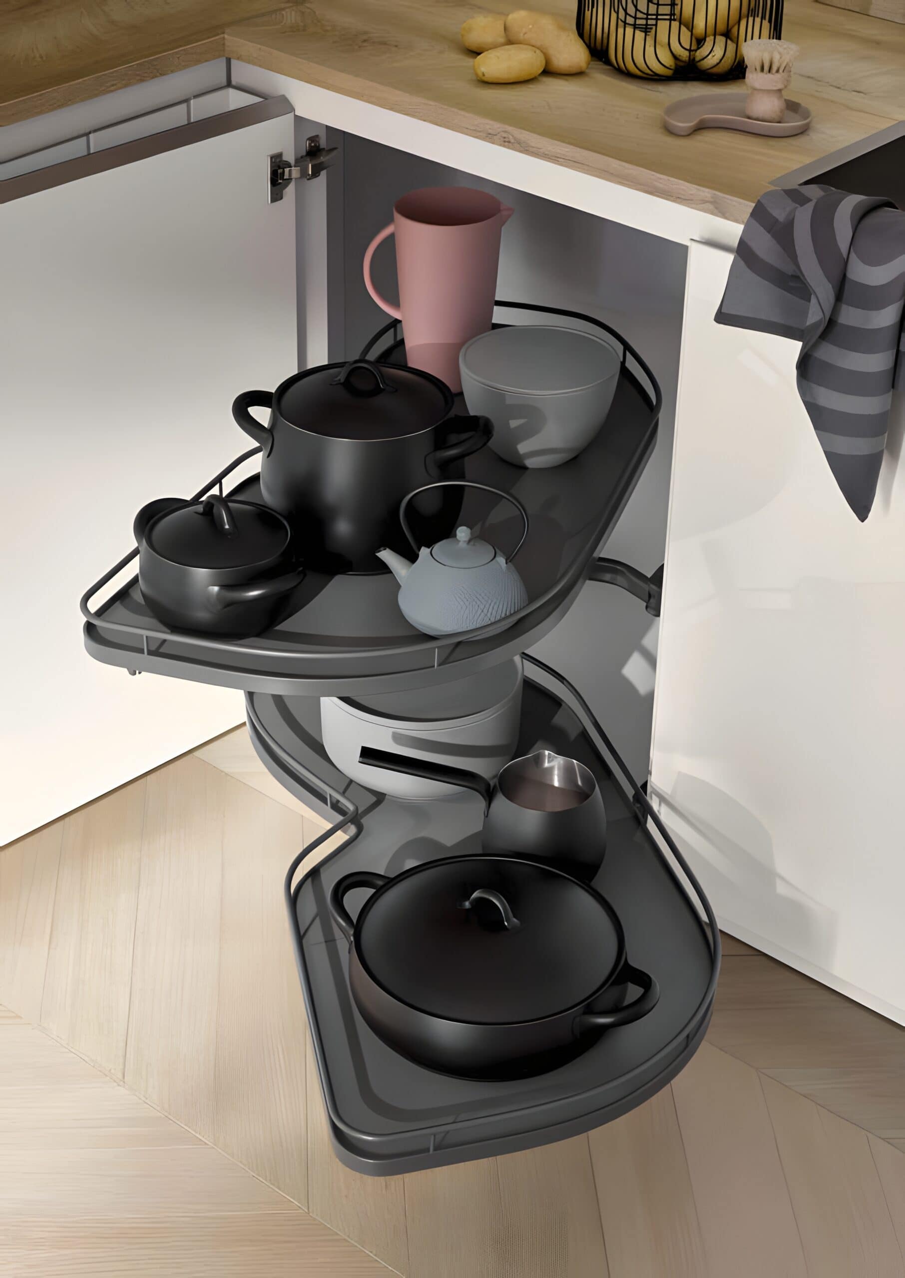 A corner kitchen cabinet with pull-out shelves featuring various black and gray pots, bowls, and a pink jug. The cabinet is open, displaying the organized kitchenware, offering eco-friendly organization ideas for kitchen cabinets. A corner kitchen cabinet with pull-out shelves featuring various black and gray pots, bowls, and a pink jug. The cabinet is open, displaying the organized kitchenware, offering eco-friendly organization ideas for kitchen cabinets.