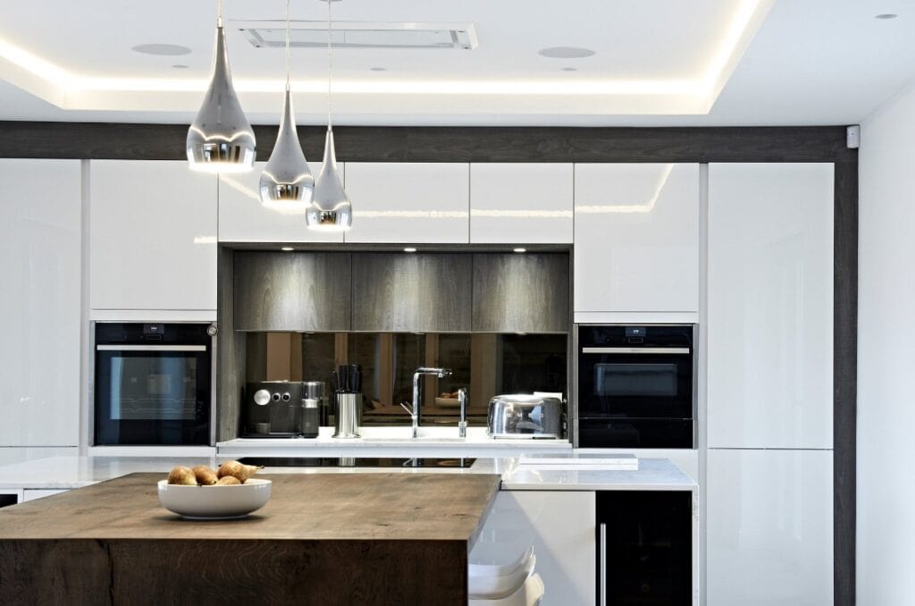 Modern kitchen featuring kitchen design trends with stainless steel appliances and layered lighting.
