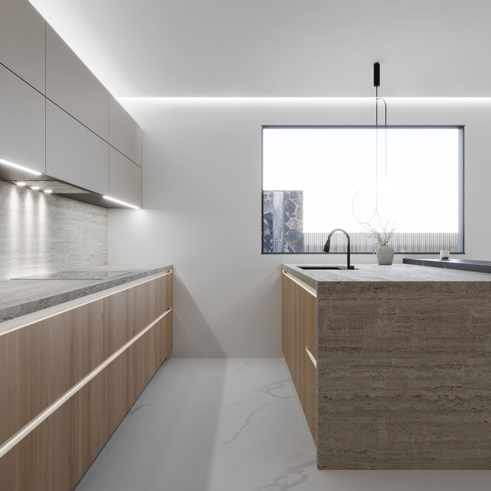 Minimalist modern kitchen with German kitchen cabinets, stone countertops, and integrated lighting, featuring a large window and a sleek hanging pendant light.